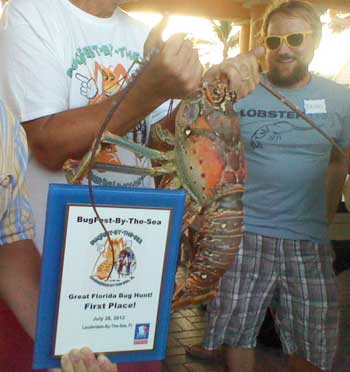 Bugfest Winners holding 9 1/2 pound Spiny Lobster and plaque