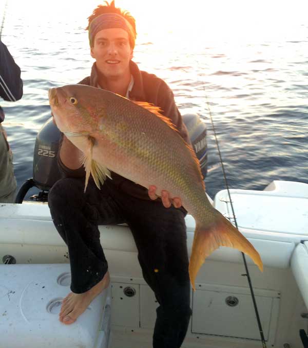 Angler holding a record 10.5 pound yellowtail snapper
