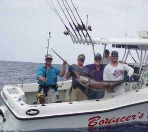 Swordfish on a boat showing all the rods and gear