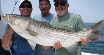 2 men holding a big striper
