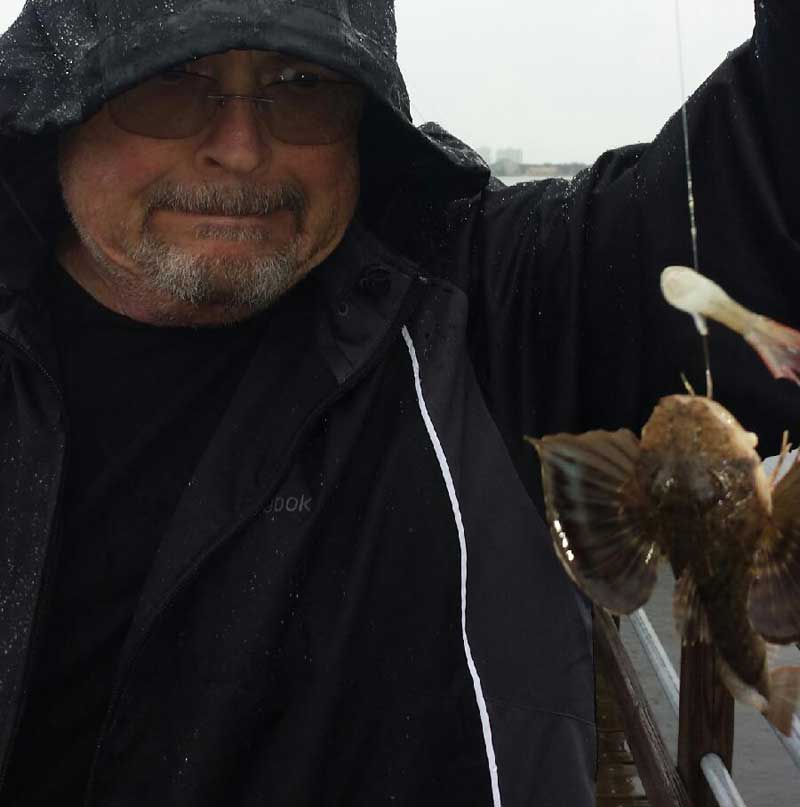 Man holding up a searobin caught in Destin