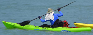 Kayaker with clothing to protect from sun
