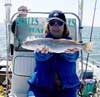 Woman holding Spotted Seatrout on boat