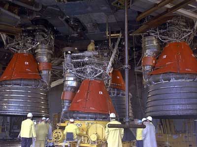 men working to install F-1 engines on ship