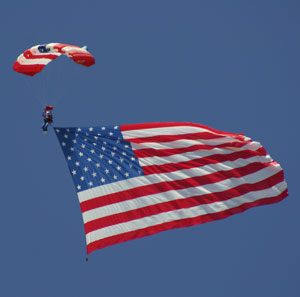 sky diver holding an american flag
