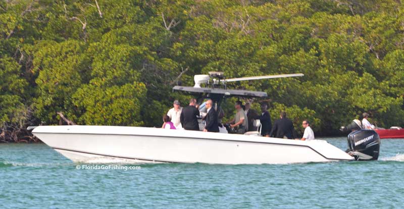 secret service men in suits on a sports boat