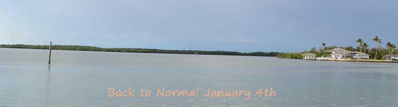 long view of Johnson's Bay with no boats on the water and the text "Back to Normal"