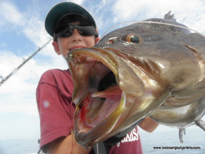Boy with fish, closeup of mouth