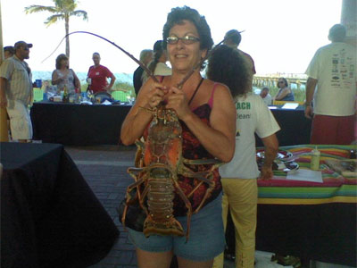 woman holding a huge spiney lobster