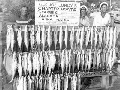 Men with a board full of fish