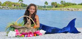little miss mermaid laying on rocks