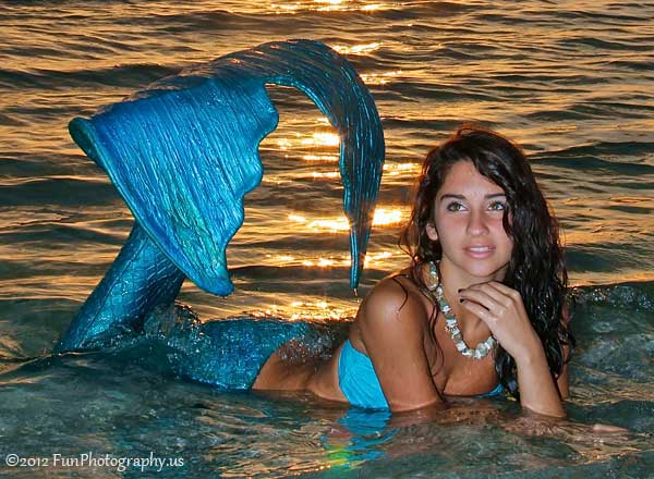 Miss Mermaid of August 2012 at the edge of the surf at sunset