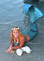 mermaid in the sand with shells