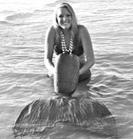 Mermaid in water holding knees black & white photo