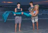 Boys holding mermaid