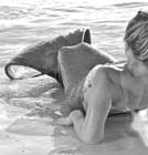Miss Mermaid sitting on beach