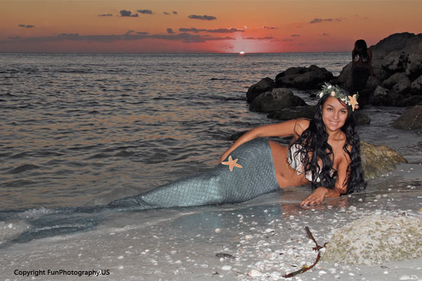 mermaid lounging on the beach with the sun setting