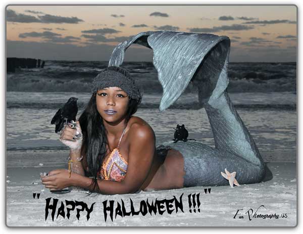 Miss November is a halloween mermaid with a rat and crow laying in the surf