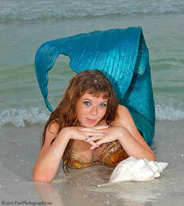Miss Lynn October 2012 mermaid of the month lays in the surf on marco island beach with a horseshoe crabs top