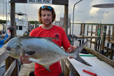 man holding a large permit fish