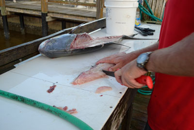 man slicing fillets into portions