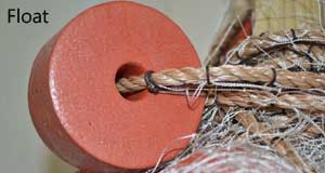 closeup of an orange colored seine net float