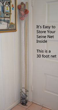 seine net rolled up and leaning in a corner behind a door